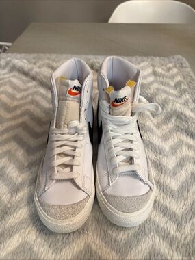 Nike White High-Top Sneakers with Black Swoosh and Orange Tongue Accent